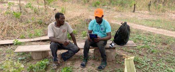 Enumerator for the JobAgri project interviewing a farmer © Hayford Opoku