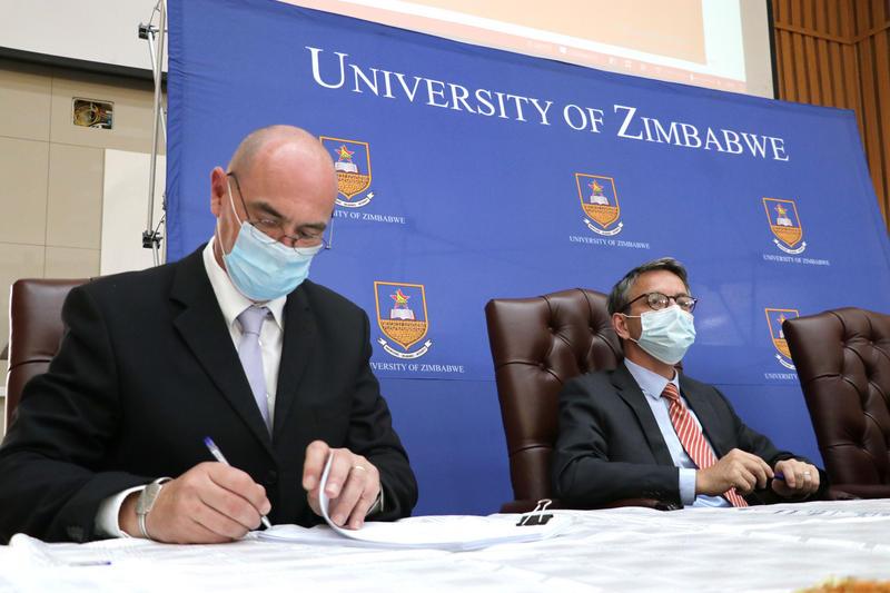 Mathieu Bourgarel, a CIRAD researcher and coordinator of the PACMAN project, signs the funding agreement, in the presence of the French Ambassador to Zimbabwe and the Dean of the University of Zimbabwe © Angela Jimu