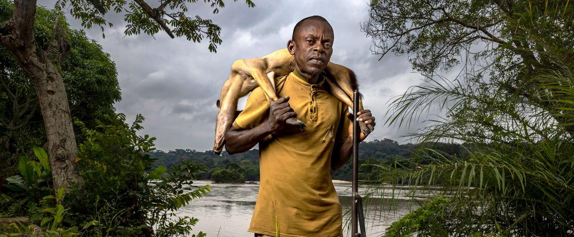 DOUME VILLAGE, CLOSE TO LASTOURSVILLE, GABON, 29 JUNE 2021: Expert bushmeat hunter Nkani Mbou Mboudin is seen with an antelope he just shot hunting in the forest around his village. This village survives on fishing and bushmeat. Gabon has a sustainable bushmeat culture, largely because of its small population and large protected habitats. (photo by Brent Stirton/Getty Images for FAO, CIFOR, CIRAD, WCS)